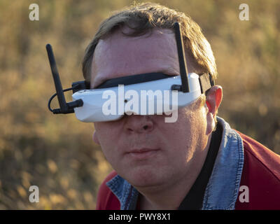 Kiev, Ukraine. 18th Oct, 2018. Drone pilot seen wearing a first-person view headset. Young man driving a quad-copter using video-goggles. Credit: Igor Golovniov/SOPA Images/ZUMA Wire/Ģ����ý Live News Stock Photo