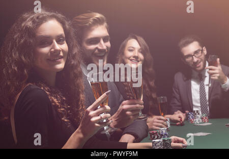 Poker players sitting around a table at a casino Stock Photo