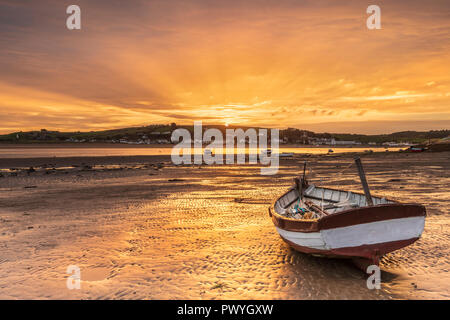 After a mild night, the little boats on the River Torridge estuary are lit up by a wonderful sunrise over  Appledore, as the weather in the South West Stock Photo