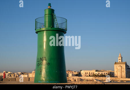 Entrance to the port at Trani, historic medieval town in Puglia, southern Italy. Photo shows the green tower marking the entrance to the harbour. Stock Photo