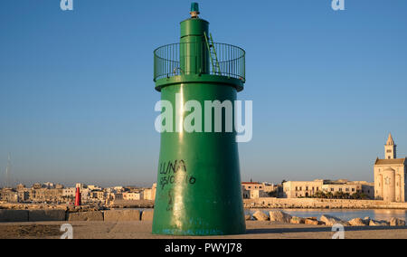 Entrance to the port at Trani, historic medieval town in Puglia, southern Italy. Photo shows the green tower marking the entrance to the harbour. Stock Photo