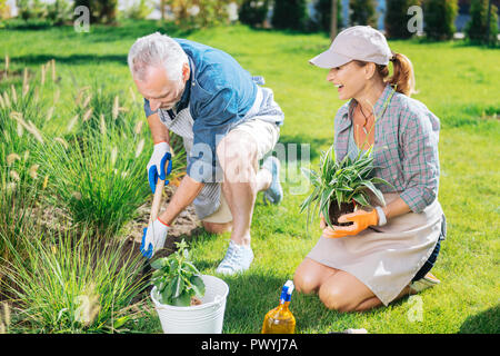 Happy beautiful couple feeling memorable while spending their day in garden Stock Photo