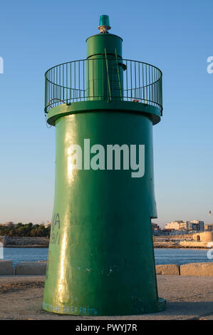 Entrance to the port at Trani, historic medieval town in Puglia, southern Italy. Photo shows the green tower marking the entrance to the harbour. Stock Photo