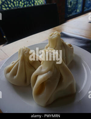 Georgian Three Steamed Meat Khinkalis Served on a Plate Stock Photo