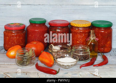 Glass jars with canned vegetables and tomatoes Stock Photo