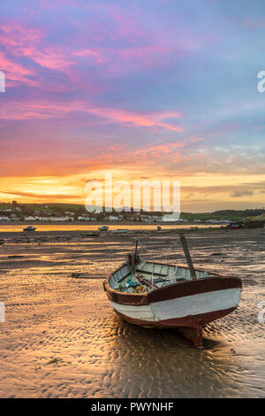 After a mild night, the little boats on the River Torridge estuary are lit up by a wonderful sunrise over  Appledore, as the weather in the South West Stock Photo