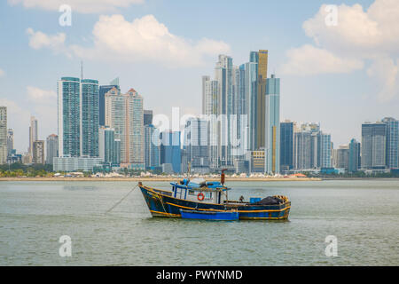 Panama City, Panama - March 2018: Old fisher boats in front of modern skyscraper city skyline in Panama City Stock Photo