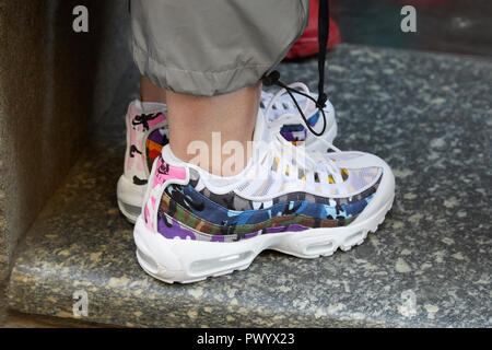 - SEPTEMBER 21, 2018: Woman with white Nike sneakers camouflage fabric before Iceberg fashion show, Fashion Week street style Stock Photo - Alamy