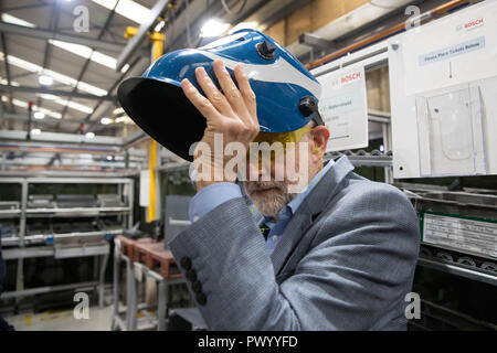 Labour leader Jeremy Corbyn wears a welding helmet during a visit to Bosch Thermotechnology in Clay Cross, Chesterfield as part of a visit to Leave voting seats in the East Midlands. Stock Photo