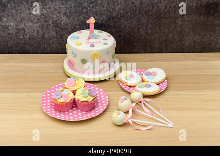 1st Birthday cake with cupcakes, cakepops and biscuits Stock Photo