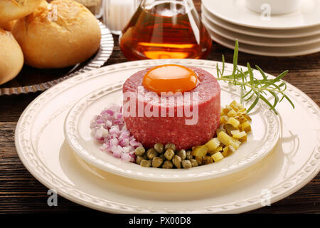 Beef steak tatare with egg, onion, cucumber and capers Stock Photo