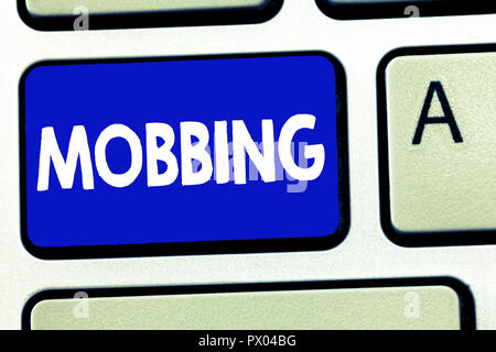 Writing note showing Mobbing. Business photo showcasing Bulling of individual specially at work Emotional abuse Stress. Stock Photo