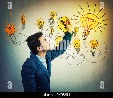 Thoughtful businessman drawing imaginative shining light bulbs. Different business thinking, genius creativity concept, alternative idea as the way to Stock Photo