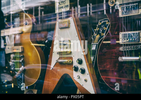 Hanks Acoustic Guitars. Old Guitars in the Shop window, Tin Pan Alley / Denmark Street, London, England. Vintage filter applied Stock Photo
