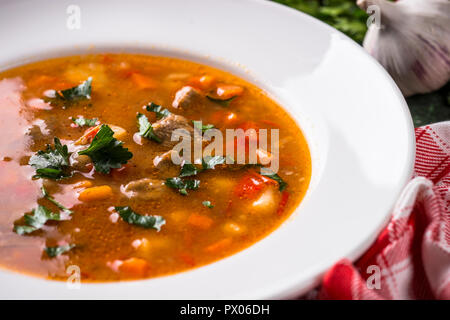 Traditional Hungarian goulash soup on the table. Stock Photo