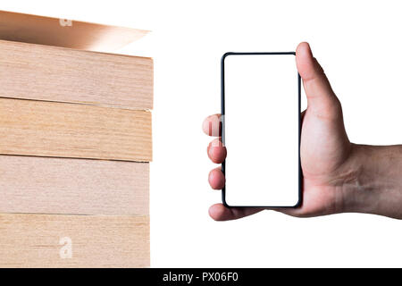 Modern bezel less smart phone with blank screen and pile of books. Technology vs traditional learning education abstract concept. Stock Photo