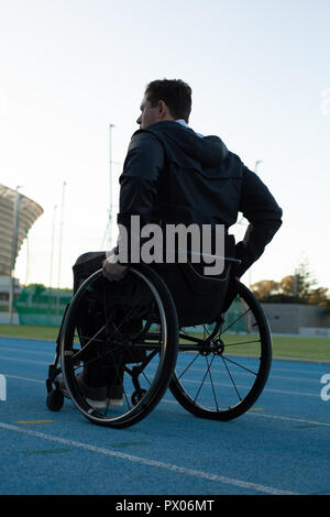 Disabled athletic moving with wheelchair at sports venue Stock Photo