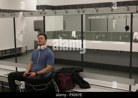 Disabled man listening music on headphones Stock Photo