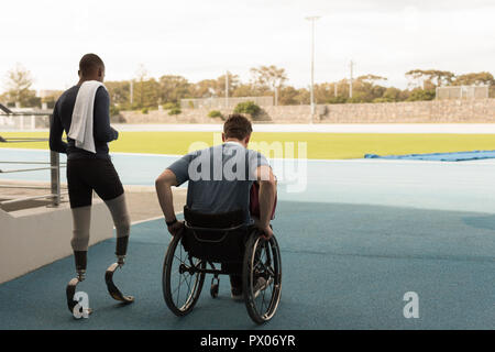 Two disabled athletics walking together on sports venue Stock Photo