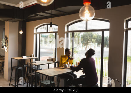 Couple interacting with each other in cafe Stock Photo