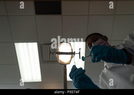 Low angle view of dentist holding tools Stock Photo