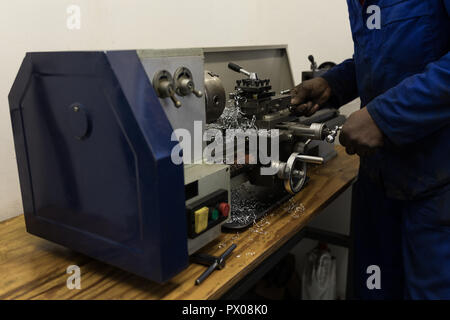 Blacksmith using machine in workshop Stock Photo