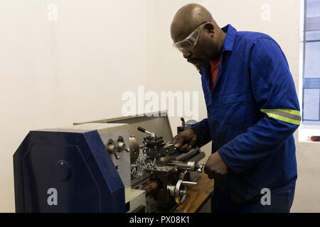 Blacksmith using machine in workshop Stock Photo