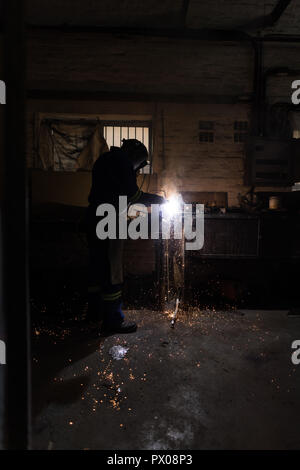 Blacksmith using a welding torch in workshop Stock Photo