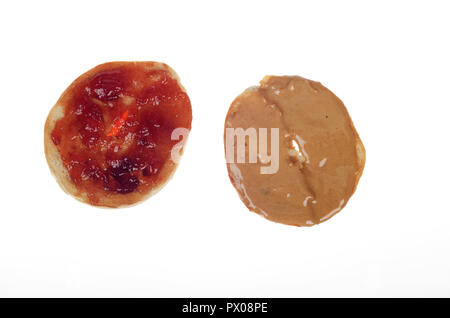 Peanut butter and strawberry jam on a sliced in half bagel on white Stock Photo