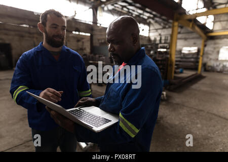Two blacksmith discussing over laptop Stock Photo