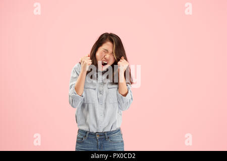Why is that. Beautiful female half-length portrait isolated on trendy pink studio backgroud. Young emotional surprised, frustrated and bewildered woman. Human emotions, facial expression concept. Stock Photo
