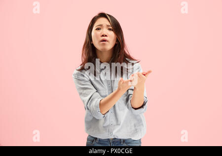 Argue, arguing concept. Beautiful female half-length portrait isolated on pink studio backgroud. Young emotional surprised woman looking at camera.Human emotions, facial expression concept. Front view Stock Photo