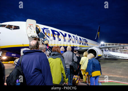 Passengers board a Ryanair aircraft for a flight from Glasgow Prestwick airport. Stock Photo