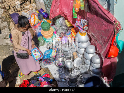 Woman selling pots and pans in outdoor market, Mawsynram, Meghalaya, India Stock Photo