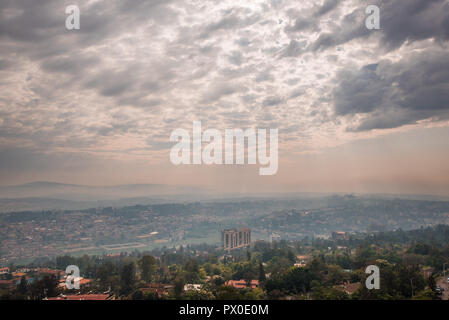 Sunlight breaks through the clouds over the hills of Rwanda that stretch into the distace Stock Photo
