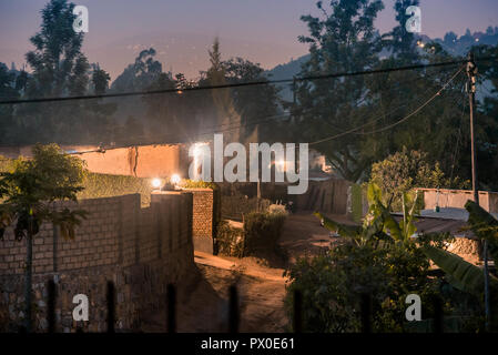 Dimly lit street scene among houses in Nyamirambo, an outlying suburb of Kigali Stock Photo