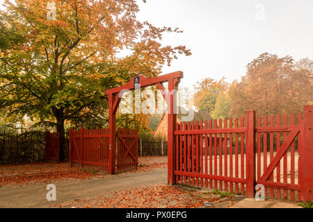 Klampenborg, Denmark - 15 october 2018: The Red Gate to Jaegersborg Dyrehave. This gate is located next to the Klampenborg Station. Autumn colors Stock Photo