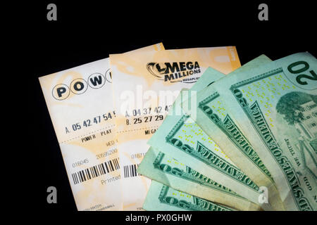 Power Ball and Mega Millions Lottery Tickets with US$ Cash Dark Black Background Stock Photo