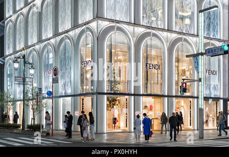 The Fendi store - part of Ginza Six shopping mall in Tokyo, Japan wit  Fendi's iconic arch glass facade, street and people in the scene. Stock Photo