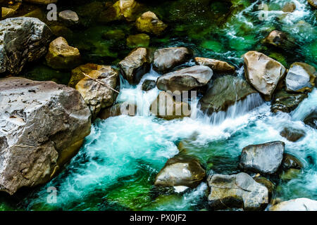 The turquoise waters of the Coquihalla River as it flows through the Coquihalla Canyon and the Othello Tunnels of the old Kettle Valley Railway in BC Stock Photo