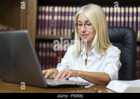 Woman using her laptop computer Stock Photo