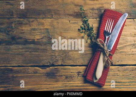 Holiday Christmas food background concept. Christmas or New Year table with a set of cutlery knife and fork on a red napkin with Christmas decorations Stock Photo