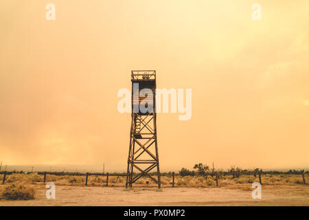 Guard Tower at the Manzanar Japanese Internment Camp in Independence California, during a smokey wildfire, bringing orange haze to the sky Stock Photo