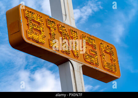 Generic BINGO neon sign in orange lights, unlit, in the daytime against a blue sky Stock Photo