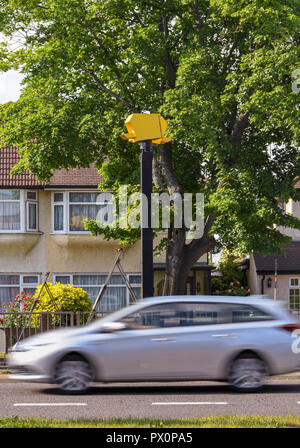 LONDON, ENGLAND - JUNE 2018: Car passing a speed camer on the Bath Road near Heathrow, with slow shutter speed used to blur the otion of the car. Stock Photo