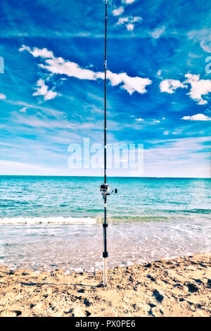 Fishing rod nailed to the seashore Stock Photo