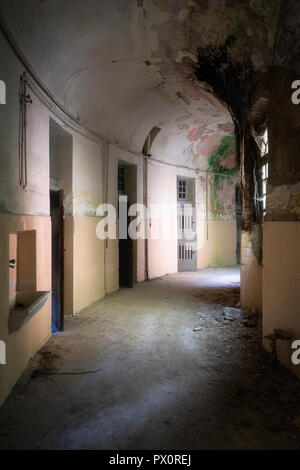 Interior view of the cells in a hallway in an abandoned hospital in Italy. Stock Photo