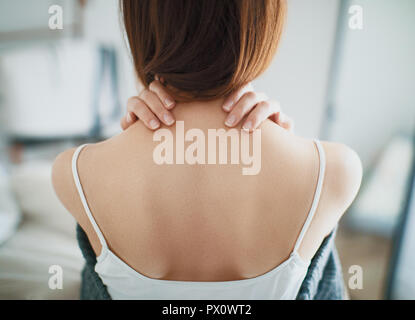 Woman with neck pain, stiff neck Stock Photo