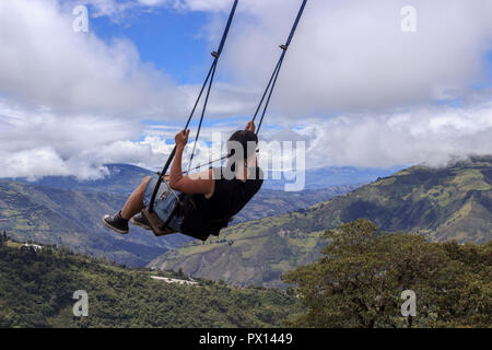 Swinging over the end of the world, ecuador Stock Photo