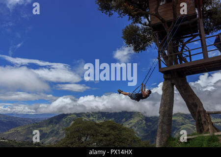 Swinging over the end of the world, ecuador Stock Photo